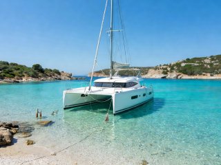 White catamaran yacht moored in pristine Ionian Bay in Greece